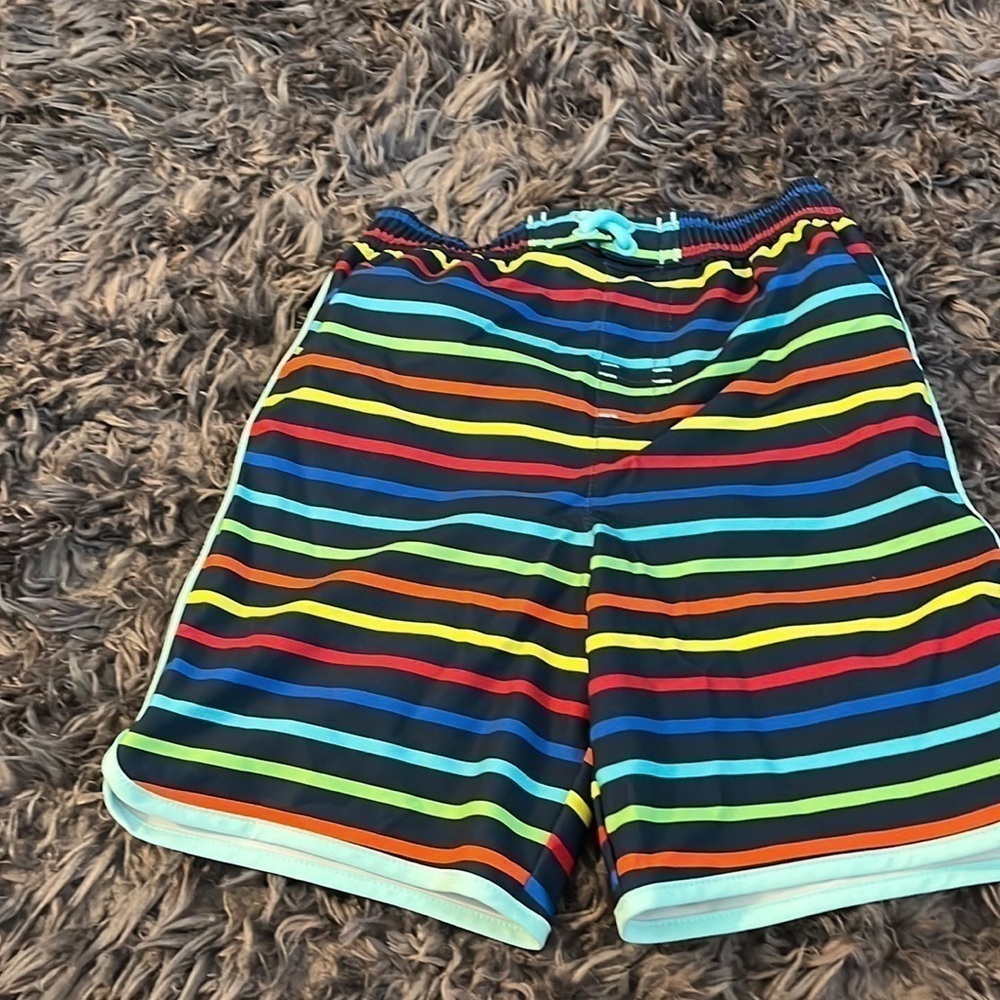 Wonder nation size 4T swim trunks.  Blue background with colorful stripes